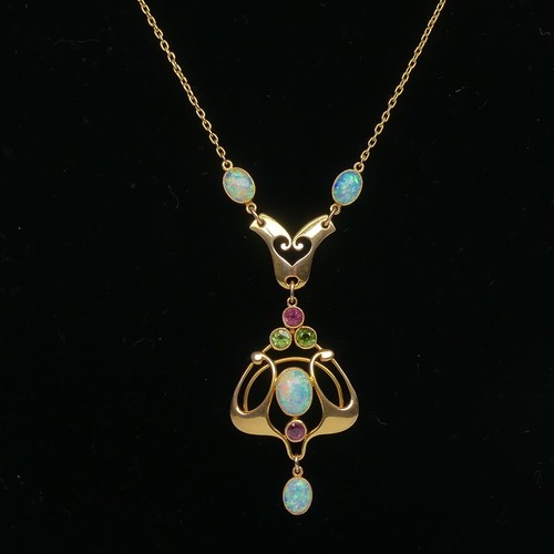 Murrle Bennett; An Art Nouveau opal Pendant, after a design by Archibald Knox, the four oval cabochon opals with two circular facetted amethysts and peridots, all millegrain set in 15ct yellow gold, marked with makers mark on reverse, on an integral trace chain, pendant 6cm long, the chain 42cm long, total weight 6.8g.