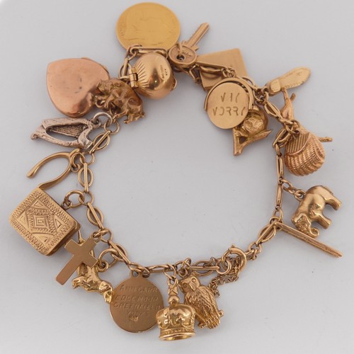 320 - A 9ct yellow gold Charm Bracelet, with bolt ring clasp, suspended with a Victorian half sovereign, d... 