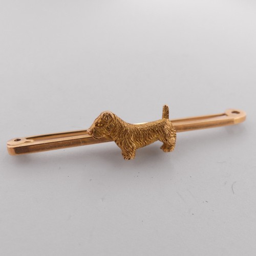 329 - A 9ct yellow gold Bar Brooch, the centre mounted with a terrier dog, 5cm long, 5g.