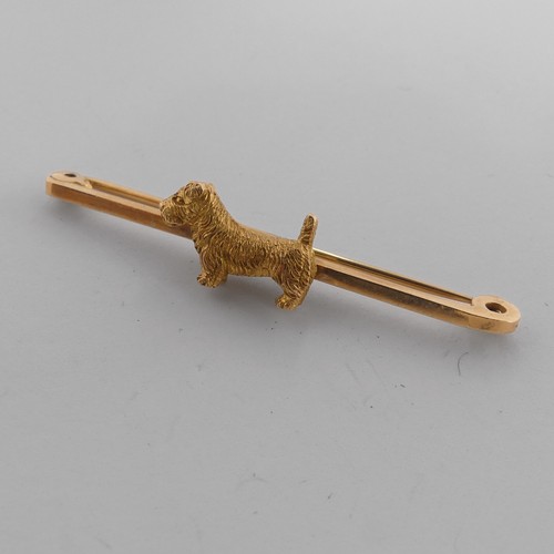 329 - A 9ct yellow gold Bar Brooch, the centre mounted with a terrier dog, 5cm long, 5g.