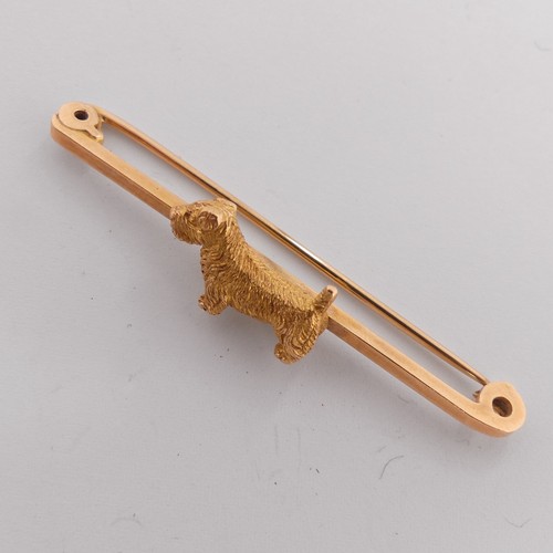 329 - A 9ct yellow gold Bar Brooch, the centre mounted with a terrier dog, 5cm long, 5g.