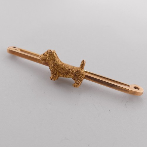 329 - A 9ct yellow gold Bar Brooch, the centre mounted with a terrier dog, 5cm long, 5g.