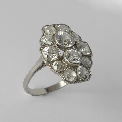 An Art Deco diamond Cluster Ring, the old cut stones millegrain set in platinum on a plain shank, the largest diamond approx. 0.6ct, estimated total diamond weight 2.88ct, Size O, 5.6g.