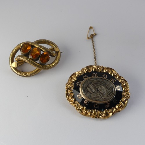 336 - A Victorian Mourning Brooch, of shaped oval form, the centre with box and glass set with woven hair,... 