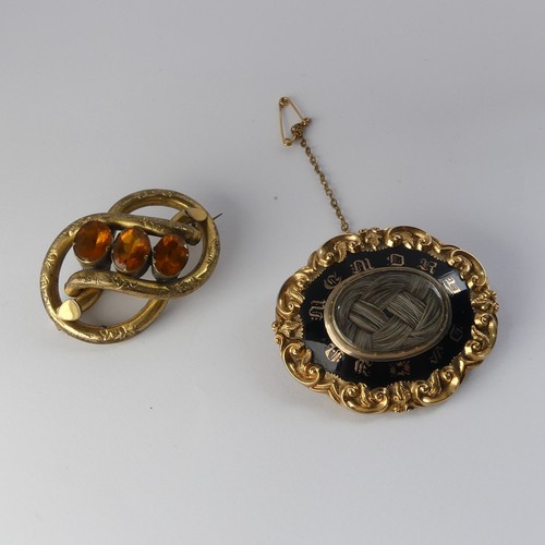 336 - A Victorian Mourning Brooch, of shaped oval form, the centre with box and glass set with woven hair,... 