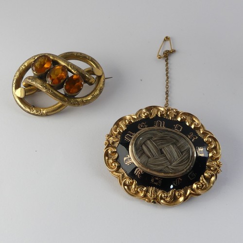 336 - A Victorian Mourning Brooch, of shaped oval form, the centre with box and glass set with woven hair,... 