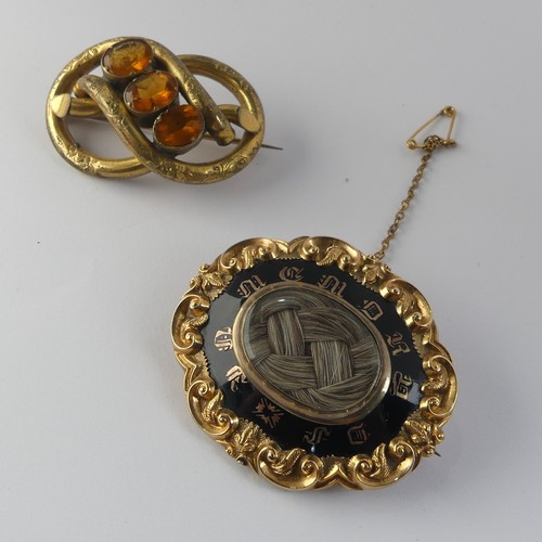 336 - A Victorian Mourning Brooch, of shaped oval form, the centre with box and glass set with woven hair,... 