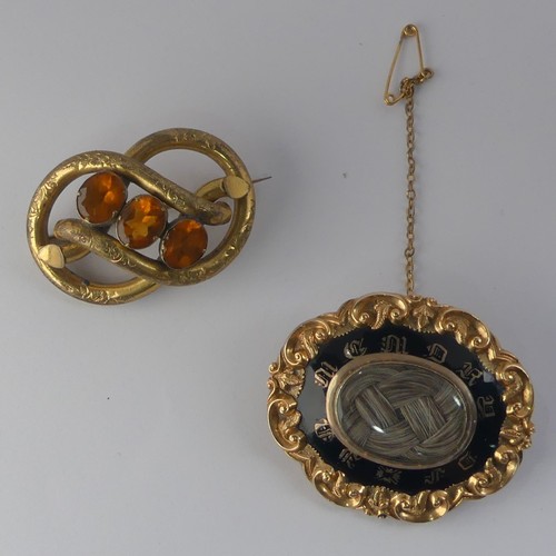 336 - A Victorian Mourning Brooch, of shaped oval form, the centre with box and glass set with woven hair,... 