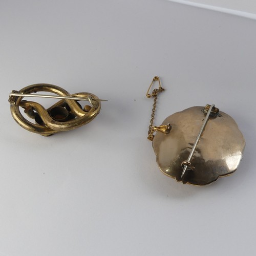 336 - A Victorian Mourning Brooch, of shaped oval form, the centre with box and glass set with woven hair,... 