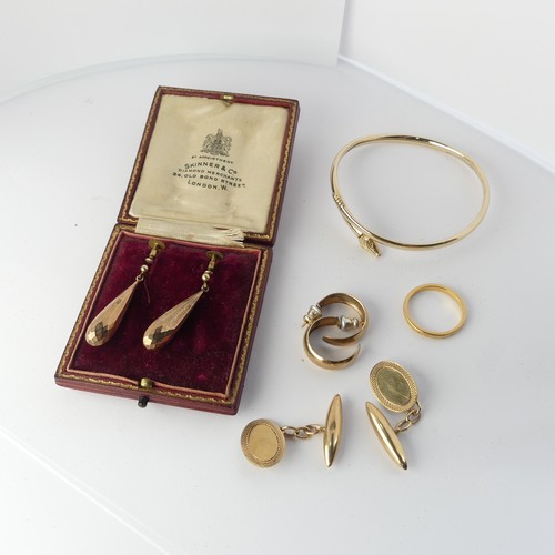 349 - A pair of 9ct gold Cufflinks, the oval fronts with bullet reverses, together with a 9ct gold bangle ... 