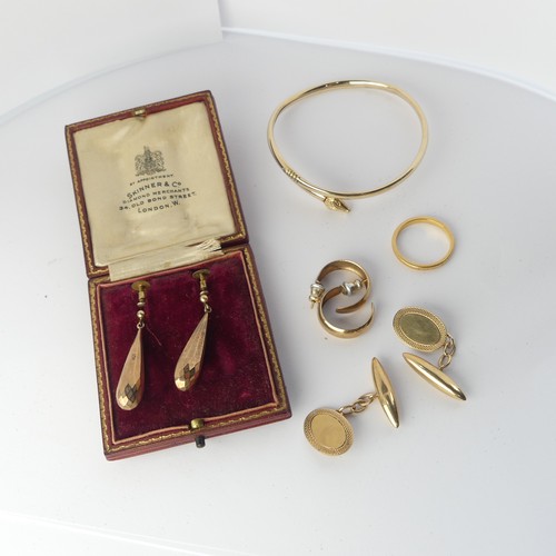 349 - A pair of 9ct gold Cufflinks, the oval fronts with bullet reverses, together with a 9ct gold bangle ... 