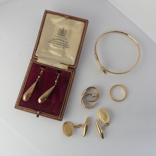 349 - A pair of 9ct gold Cufflinks, the oval fronts with bullet reverses, together with a 9ct gold bangle ... 