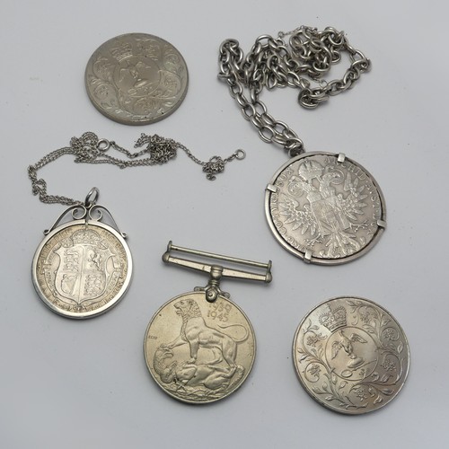 352 - A George V Half Crown, dated 1916, in silver pendant mount, together with a mounted Thaler, dated 17... 