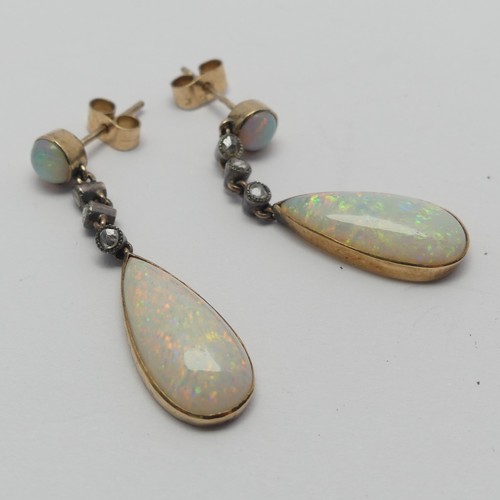 327 - A pair of opal drop Earrings, the pear shaped stones approx. 17.8mm long collet set in yellow gold b... 