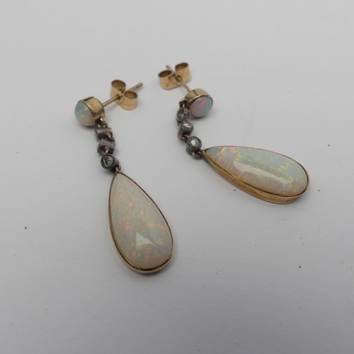 327 - A pair of opal drop Earrings, the pear shaped stones approx. 17.8mm long collet set in yellow gold b... 