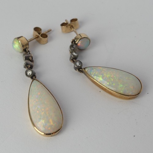 327 - A pair of opal drop Earrings, the pear shaped stones approx. 17.8mm long collet set in yellow gold b... 