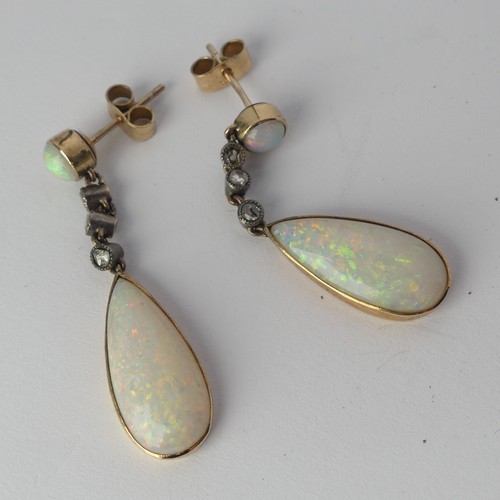 327 - A pair of opal drop Earrings, the pear shaped stones approx. 17.8mm long collet set in yellow gold b... 