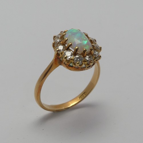 274 - An opal and diamond cluster Ring, the central oval cabochon opal, approx. 8.8mm long, claw set withi... 