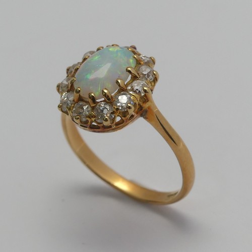 274 - An opal and diamond cluster Ring, the central oval cabochon opal, approx. 8.8mm long, claw set withi... 