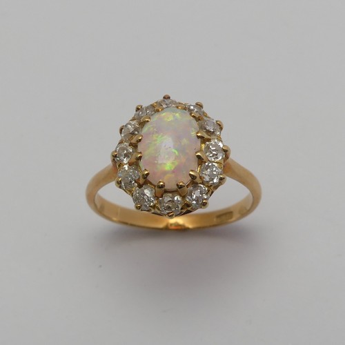 274 - An opal and diamond cluster Ring, the central oval cabochon opal, approx. 8.8mm long, claw set withi... 