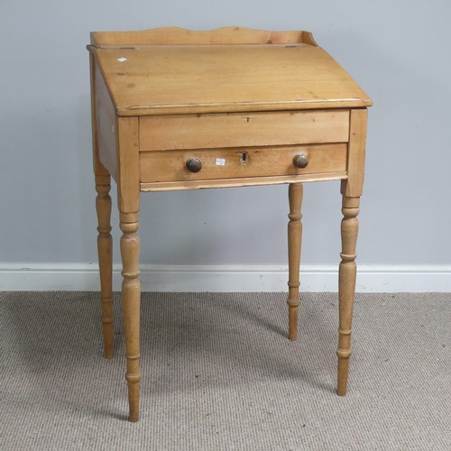 514 - An antique pine clerks Desk, sloped fall front above single drawer, raised on four turned supports, ... 