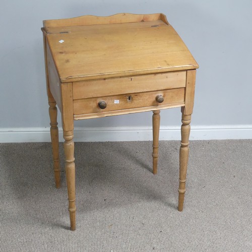 514 - An antique pine clerks Desk, sloped fall front above single drawer, raised on four turned supports, ... 