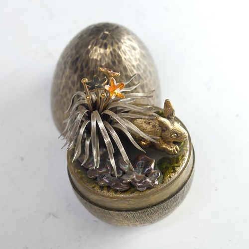 51 - Stuart Devlin; A silver gilt 'Surprise Egg', hallmarked London 1981, the textured egg opening to rev... 