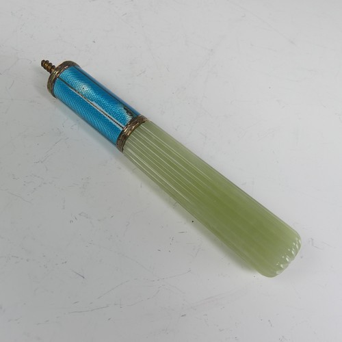 An early 20thC Russian jade and enamel Cane / Parasol Handle, in the manner of Fabergé but marked 72 zoloniks (18ct) only, the fluted bowenite handle with a two-colour gold mounted blue guilloche enamel surmount and integral screw thread, 12.5cm long, some damage to the enamel.