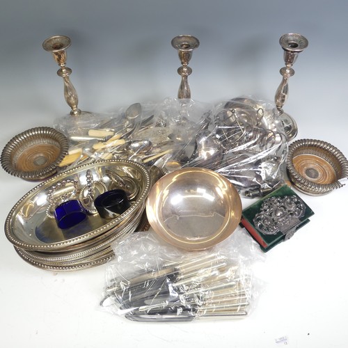 65 - A quantity of Silver Plate, including a pair of candlesticks, entree dishes, bottle coaster, flatwar... 