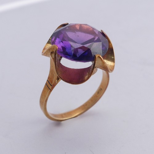 280 - A synthetic sapphire Ring, the colour change circular facetted stone approx. 13.75mm diameter, mount... 