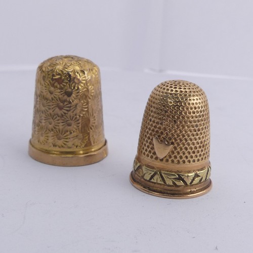 368 - A 9ct gold Thimble, with foliate engraved decoration, 20mm high, together with another unmarked in t... 