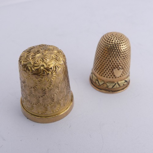 368 - A 9ct gold Thimble, with foliate engraved decoration, 20mm high, together with another unmarked in t... 