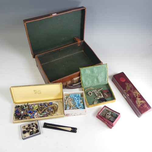 373 - A vintage leather case containing a quantity of Costume Jewellery, including a garnet cluster pendan... 