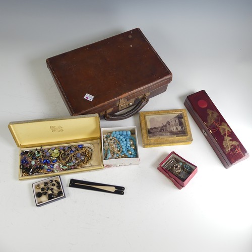 373 - A vintage leather case containing a quantity of Costume Jewellery, including a garnet cluster pendan... 