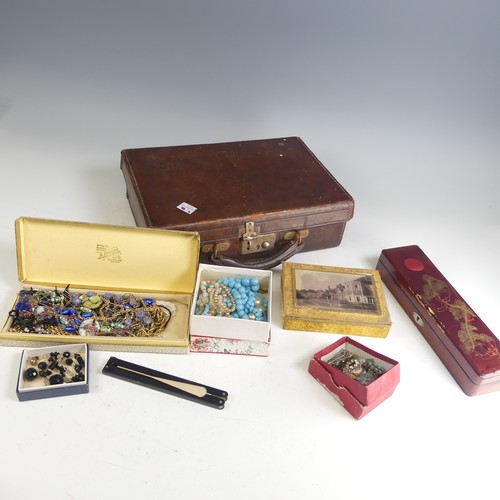 373 - A vintage leather case containing a quantity of Costume Jewellery, including a garnet cluster pendan... 