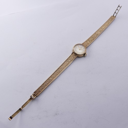 216 - A 9ct yellow gold lady's Tissot Wristwatch, 12mm diameter, on an integral 9ct gold mesh bracelet str... 