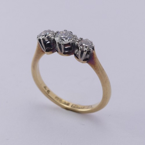 250 - A three stone diamond Ring, the centre stone approx. 0.21ct, with a smaller stone on either side, ap... 