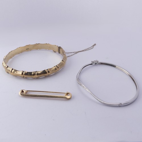 381 - A 9ct yellow gold hinged Bangle, with stylised bamboo texturing,together with a narrow 9ct white gol... 