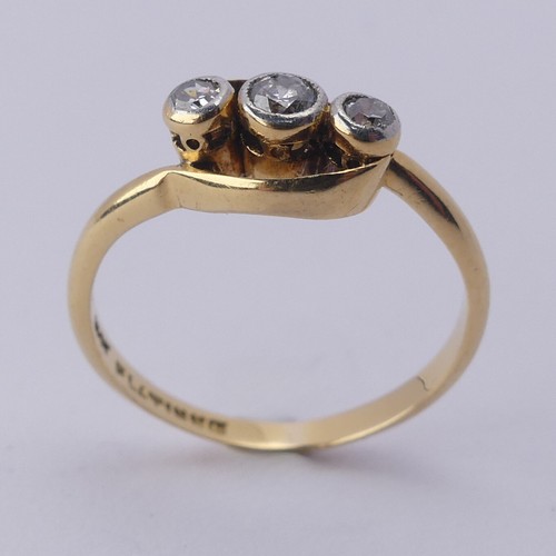 251 - A small three stone diamond Ring, millegrain set on the cross in 18ct yellow gold and platinum, Size... 