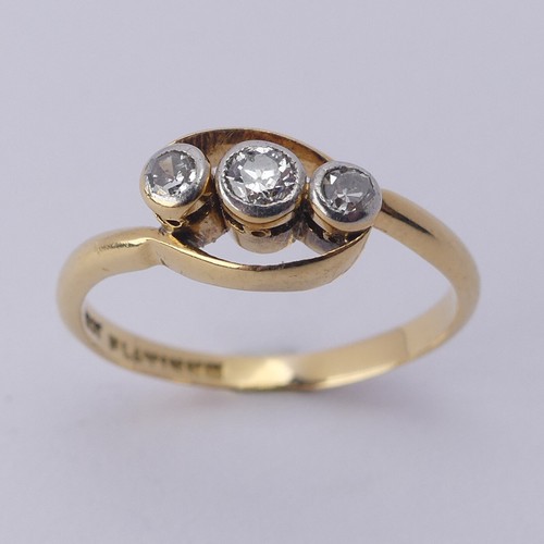 251 - A small three stone diamond Ring, millegrain set on the cross in 18ct yellow gold and platinum, Size... 