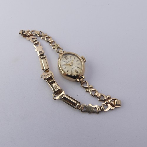 224 - A 9ct gold lady's Wristwatch, on 9ct bracelet strap, gross total weight 9.1g.