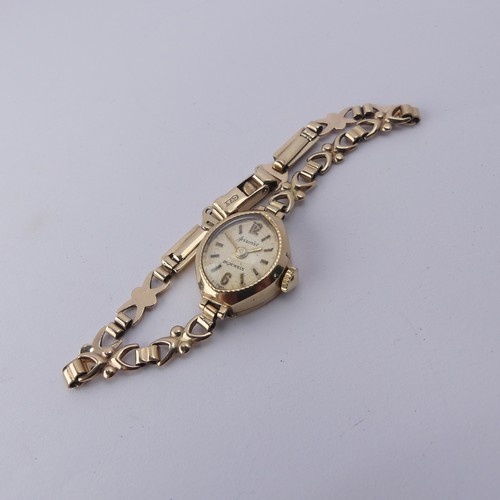 224 - A 9ct gold lady's Wristwatch, on 9ct bracelet strap, gross total weight 9.1g.