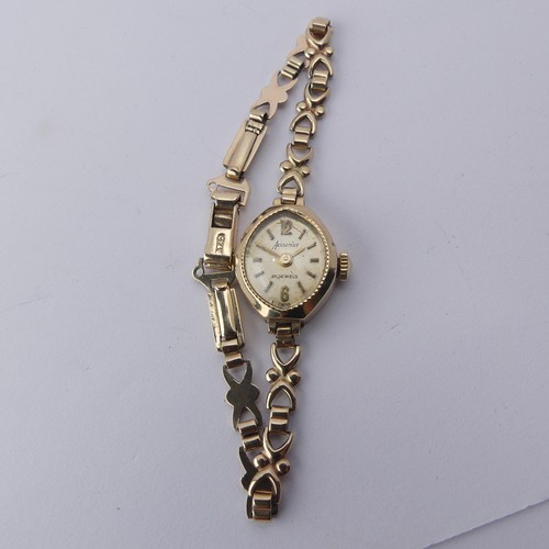 224 - A 9ct gold lady's Wristwatch, on 9ct bracelet strap, gross total weight 9.1g.