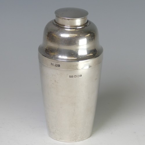 A silver Art Deco Cocktail Shaker, by Walker & Hall, hallmarked Sheffield, 1928, of typical form with pull off cover, screw fitting pourer cover revealing pierced strainer, all parts correspondingly hallmarked, the body monogrammed, 18cm high, total weight 13.2ozt.
