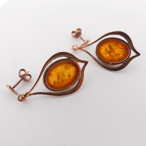 342 - A pair of 9ct gold mounted amber drop Earrings, the cabochon stones 16mm long, overall drop 4.5cm, t... 