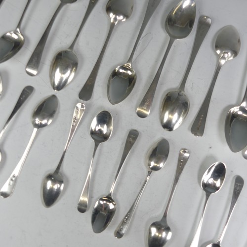 150 - A matched set of twelve George III silver Dessert Spoons, Old English pattern, various dates and mak... 