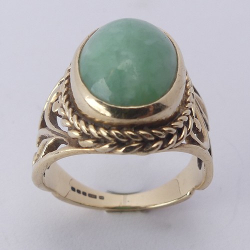 257 - A jade Dress Ring, the oval cabochon stone approx. 13mm long, collet set in ropetwist mount with scr... 