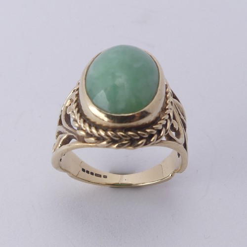 257 - A jade Dress Ring, the oval cabochon stone approx. 13mm long, collet set in ropetwist mount with scr... 