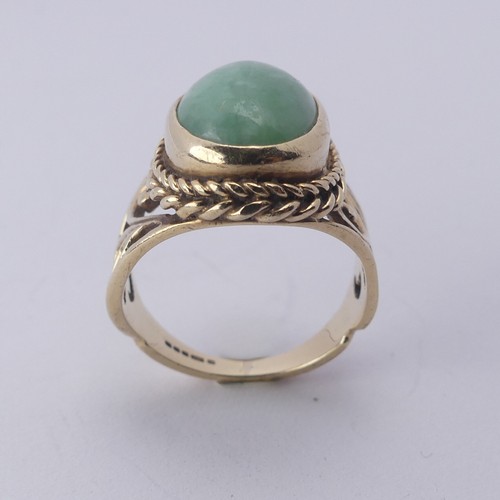 257 - A jade Dress Ring, the oval cabochon stone approx. 13mm long, collet set in ropetwist mount with scr... 