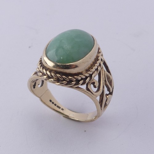 257 - A jade Dress Ring, the oval cabochon stone approx. 13mm long, collet set in ropetwist mount with scr... 